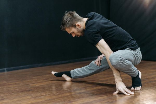Close up of a man performing stretching exercises for better mobility.